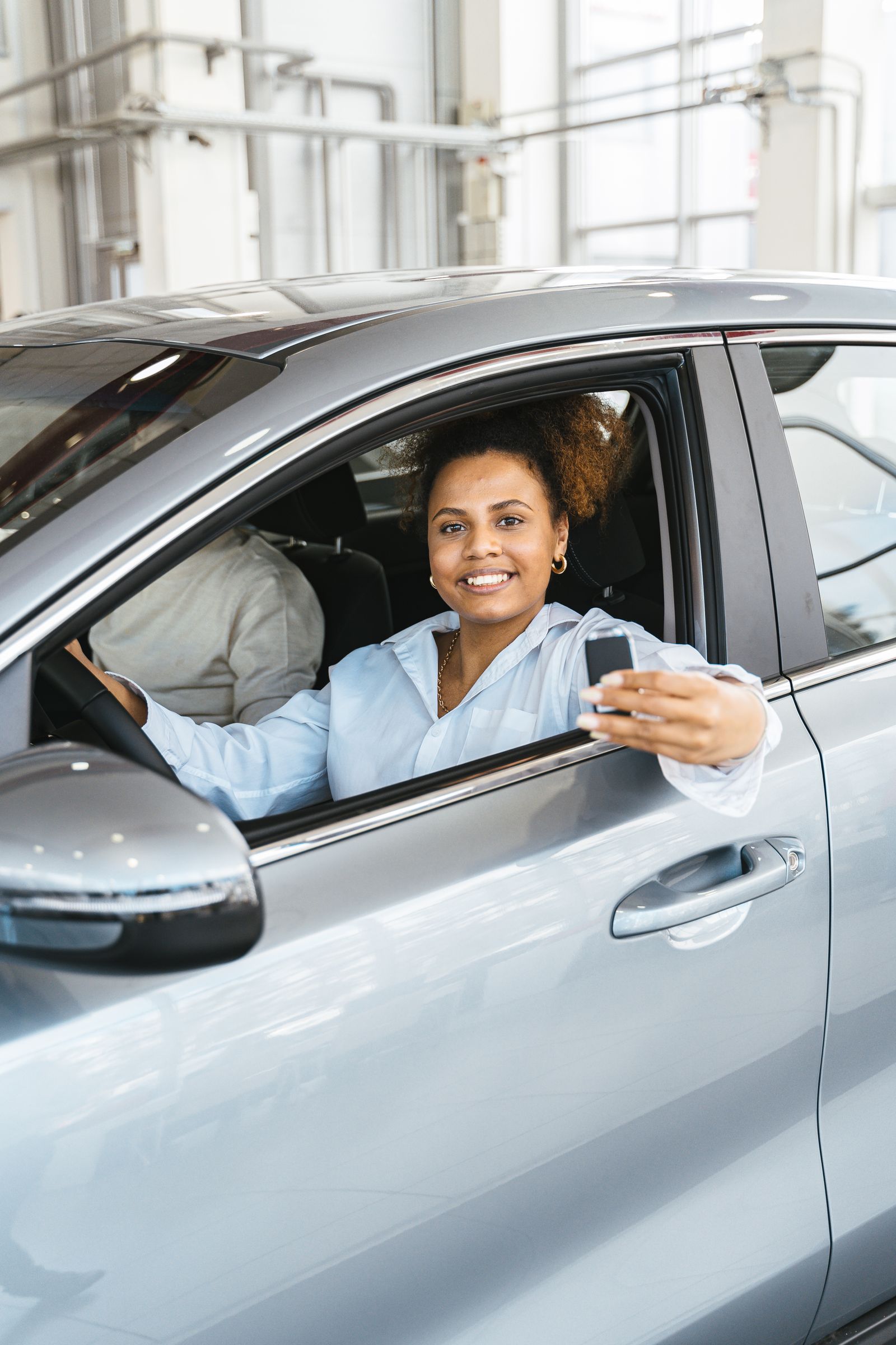 Driver receiving financing beside his car